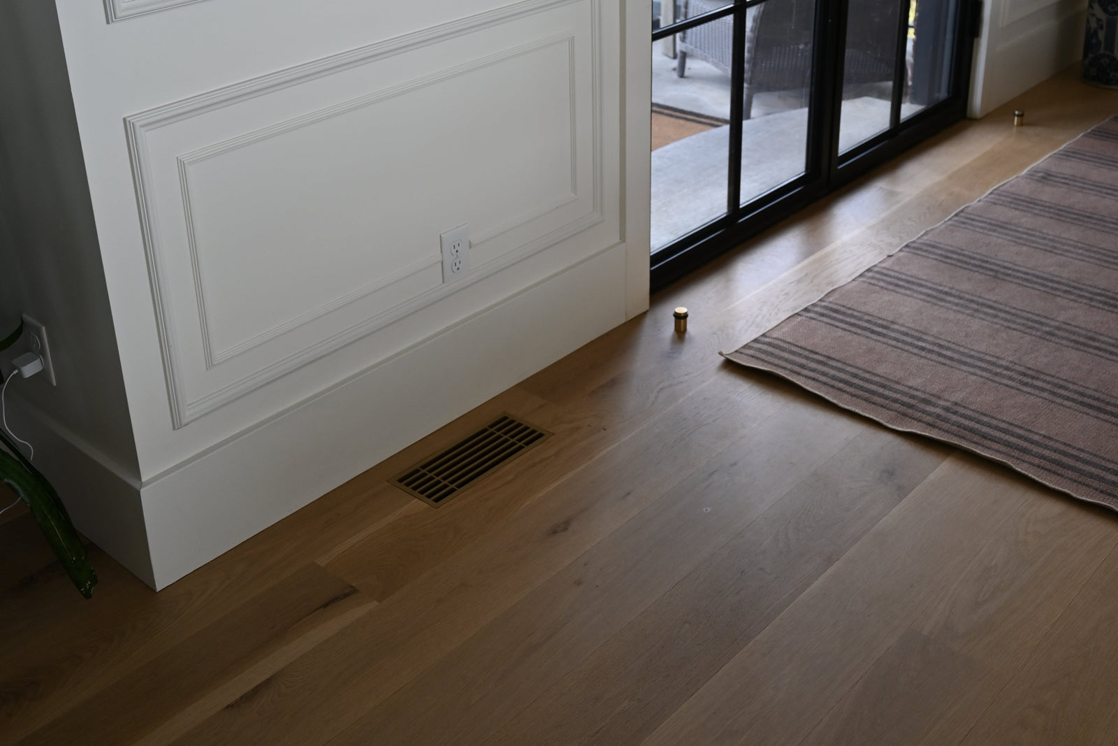 Bar · Vintage Gold flush floor vent in a wood floor