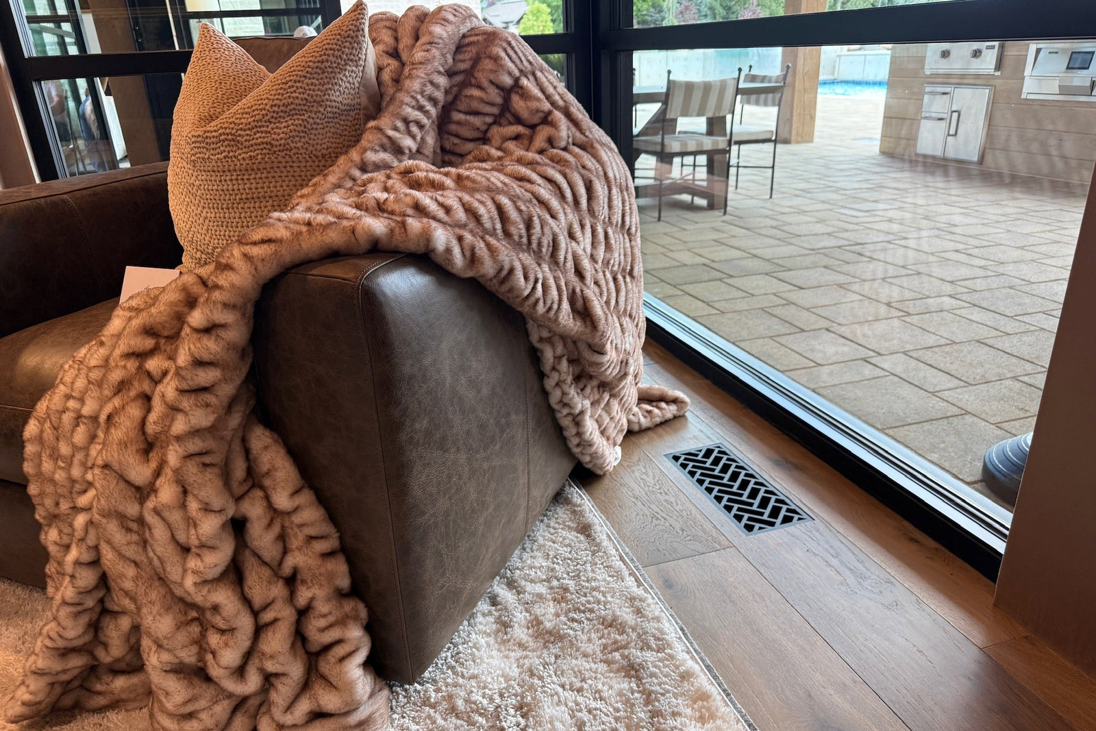 Herringbone · Matte Bronze flush floor vent in a wood floor