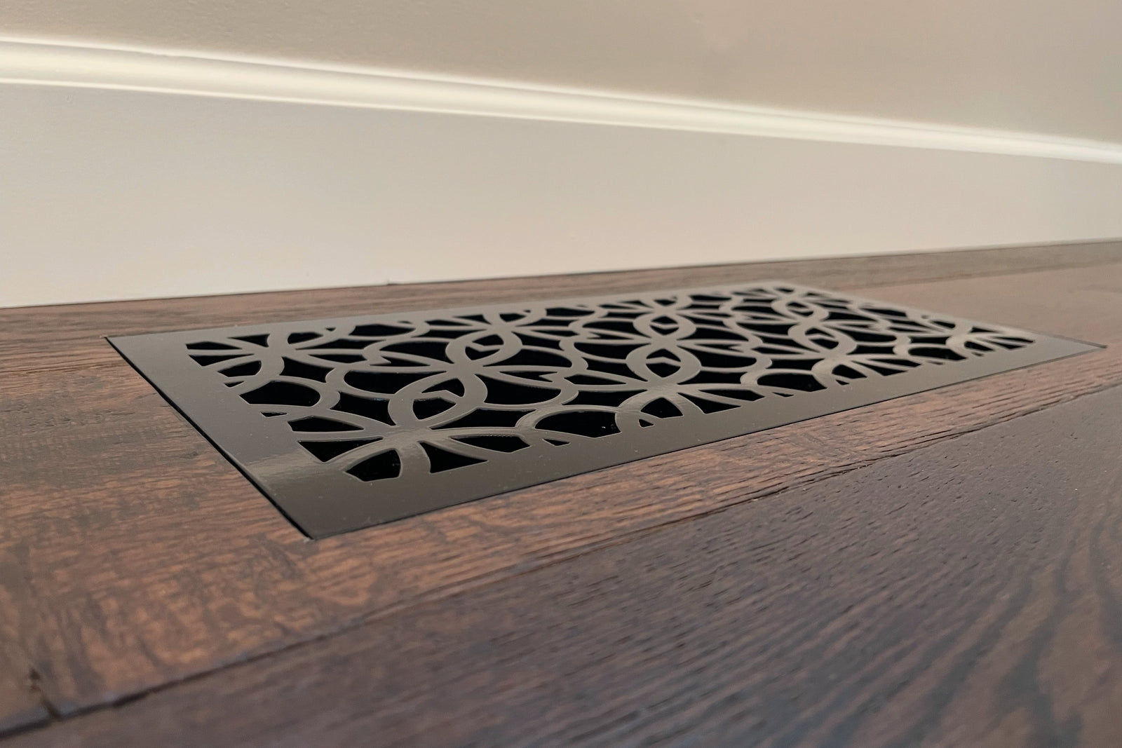 Laurel flush floor vent in a wood floor