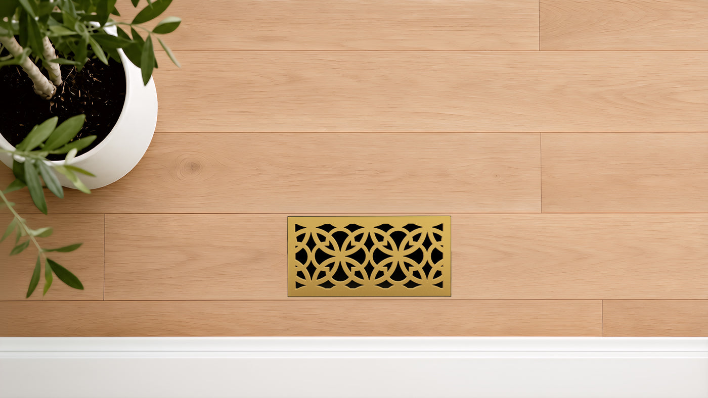 Laurel · Vintage Gold flush floor vent in a wood floor